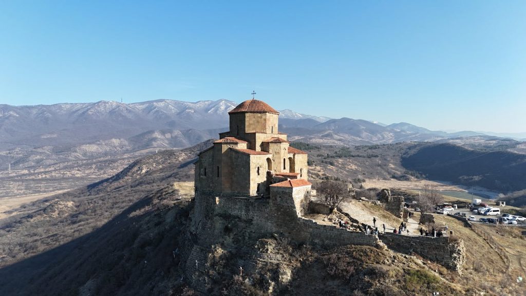 pexels-photo-29874564 Breathtaking drone shot of the ancient Jvari Monastery in Georgia surrounded by mountains.